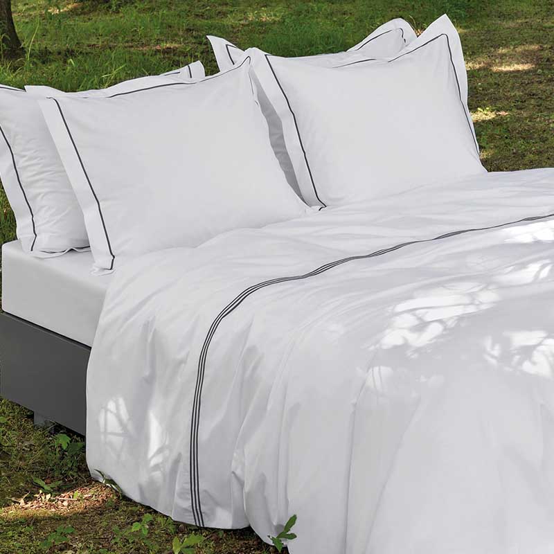 bed op gras met wit dekbedovertrek van percal katoen